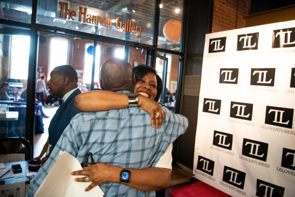 A book launch brunch for "Ghost Stories: The Legend of Principal Joe Clark," a book of stories collected by Leila Grubbs about Principal Joe Clark and his influence on the lives of former students of Eastside High School. (Center) Grubbs hugs former Eastside student Kenny Sutton at The Paterson Museum on Saturday, June 11, 2022.