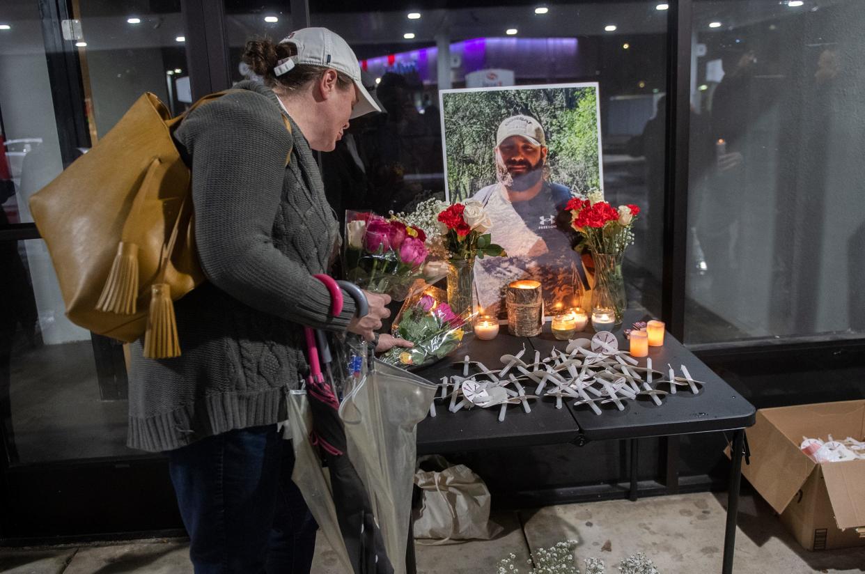 Nikki Lowery places some flowers at a memorial during a vigil for Rico Ruiz-Altamirano at the Hammer Landing shopping center in Stockton on Saturday, Jan. 14, 2023. Ruiz-Altamirano  was killed in an officer involved shooting at the Excel gas station in the shopping center on Tuesday, Jan. 10.