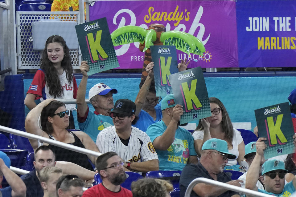 Fans celebrate after Miami Marlins starting pitcher Sandy Alcantara struck out Cincinnati Reds second baseman Jonathan India during the fifth inning of a baseball game, Saturday, May 13, 2023, in Miami. (AP Photo/Wilfredo Lee)