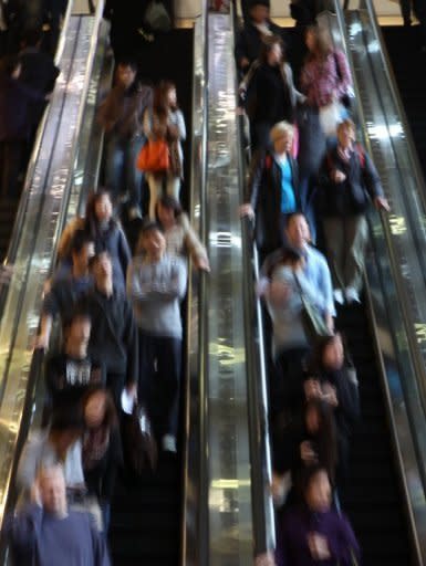 File photo shows people on an escalator in Hong Kong. Younger Hong Kong residents typically live at home deep into their 20s or 30s because they can't afford to marry and move out earlier, meaning that many sleep in close proximity to their parents in cramped apartments