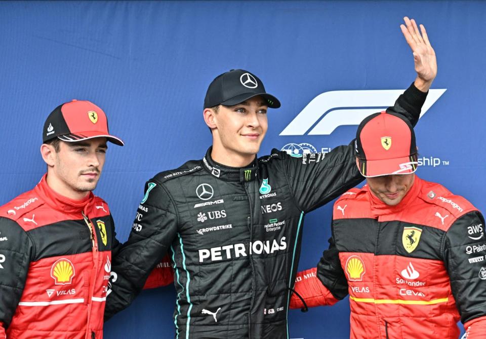 George Russell (centre) celebrates his pole position in Hungary in July (AFP/Getty)