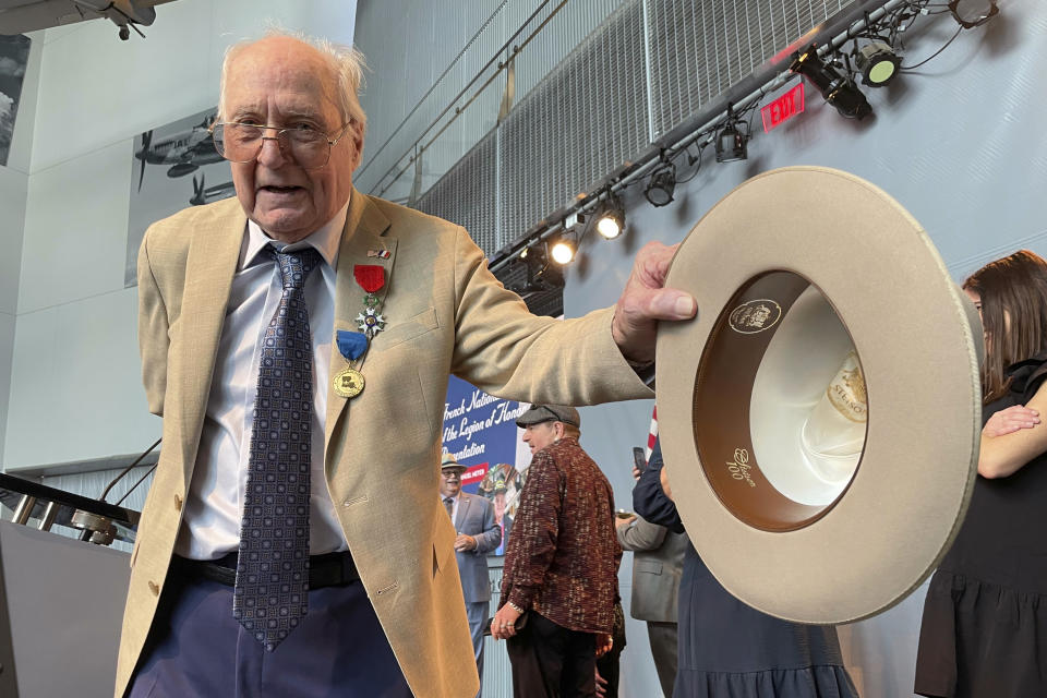 Long time local retailer Samuel Meyer, 99, shows off a Stetson hat following ceremonies at the National World War II Museum, where he was awarded membership in the French Legion of Honor on Tuesday, Feb. 27, 2024, in New Orleans. Meyer is known as one of the longtime proprietors of Meyer the Hatter, begun by his grandfather in 1994. (AP Photo/Kevin McGill)