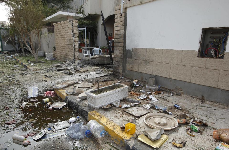 A general view of the damage caused by a bomb blast is seen at the gate of the Iranian ambassador's residence in Tripoli