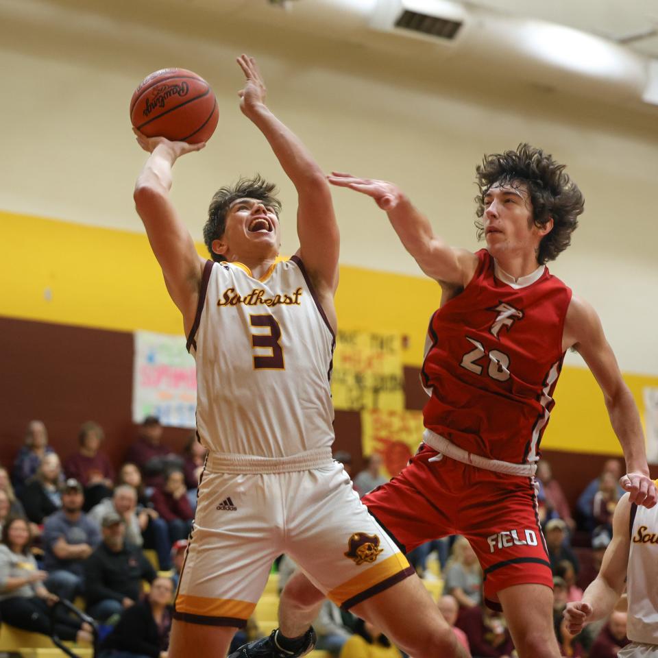 Southeast senior Garrett Sprutte goes up for a shot against Field’s Nick Papiska during Saturday night’s game at Southeast High School.