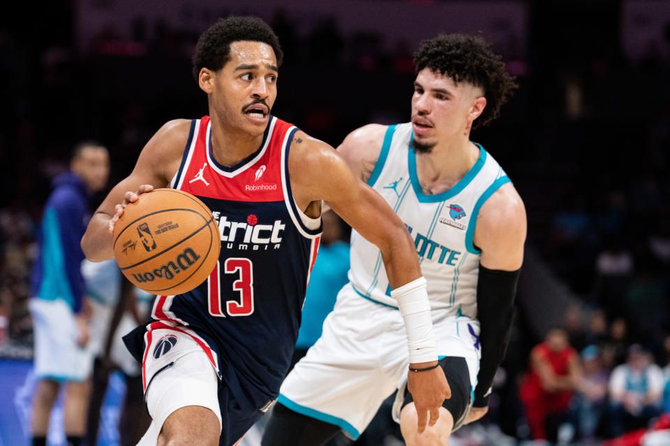 CHARLOTTE, NORTH CAROLINA - NOVEMBER 08: Jordan Poole #13 of the Washington Wizards drives to the basket past LaMelo Ball #1 of the Charlotte Hornets in the first quarter during their game at Spectrum Center on November 08, 2023 in Charlotte, North Carolina. NOTE TO USER: User expressly acknowledges and agrees that, by downloading and or using this photograph, User is consenting to the terms and conditions of the Getty Images License Agreement. (Photo by Jacob Kupferman/Getty Images)