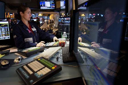 Trader Amanda Anderson works on the floor of the New York Stock Exchange after the opening bell in New York, December 24, 2013. REUTERS/Carlo Allegri