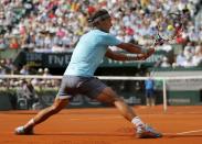 Rafael Nadal of Spain returns the ball to Novak Djokovic of Serbia during their men's singles final match at the French Open Tennis tournament at the Roland Garros stadium in Paris June 8, 2014. REUTERS/Stephane Mahe (FRANCE - Tags: SPORT TENNIS)