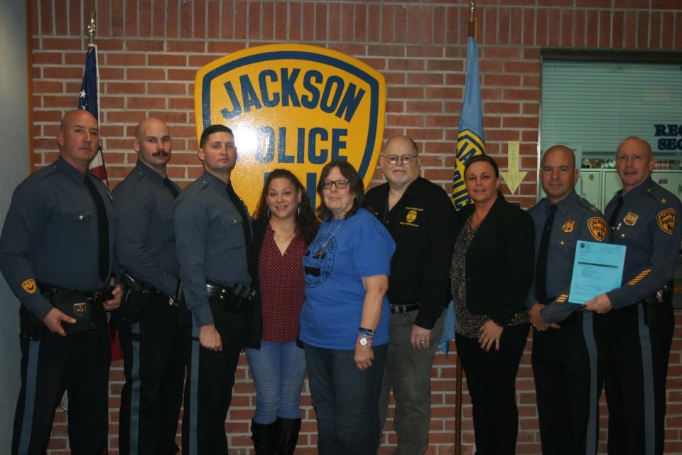 Members of the department after receiving a donation for their K-9 unit. From left to right: P.O. Phil Minissale, P.O. Matt Jamison, P.O. Nick Kokich, Toni Tedusco. Tina Kanterman, Stan Kanterman, Capt. Mary Nelson, Capt. George Vidalis, Chief Matthew D. Kunz