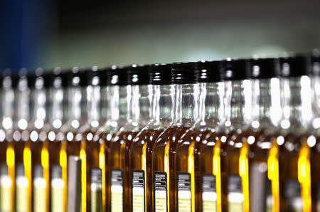 FILE PHOTO: Bottles of olive oil are lined in a factory in Dos Hermanas, near the Andalusian capital of Seville September 21, 2012. REUTERS/Marcelo del Pozo/File Photo