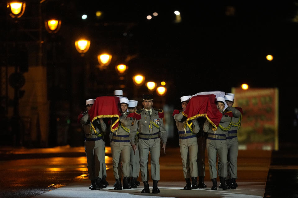 Soldiers of the Foreign Legion carry Missak Manouchian and his wife Mélinée Manouchian's coffins, Wednesday, Feb. 21, 2024 in Paris. While France hosts grandiose ceremonies commemorating D-Day, Missak Manouchian and his Resistance fighters' heroic role in World War II are often overlooked. French President Emmanuel Macron is seeking to change that by inducting Manouchian into the Panthéon national monument. (AP Photo/Michel Euler)