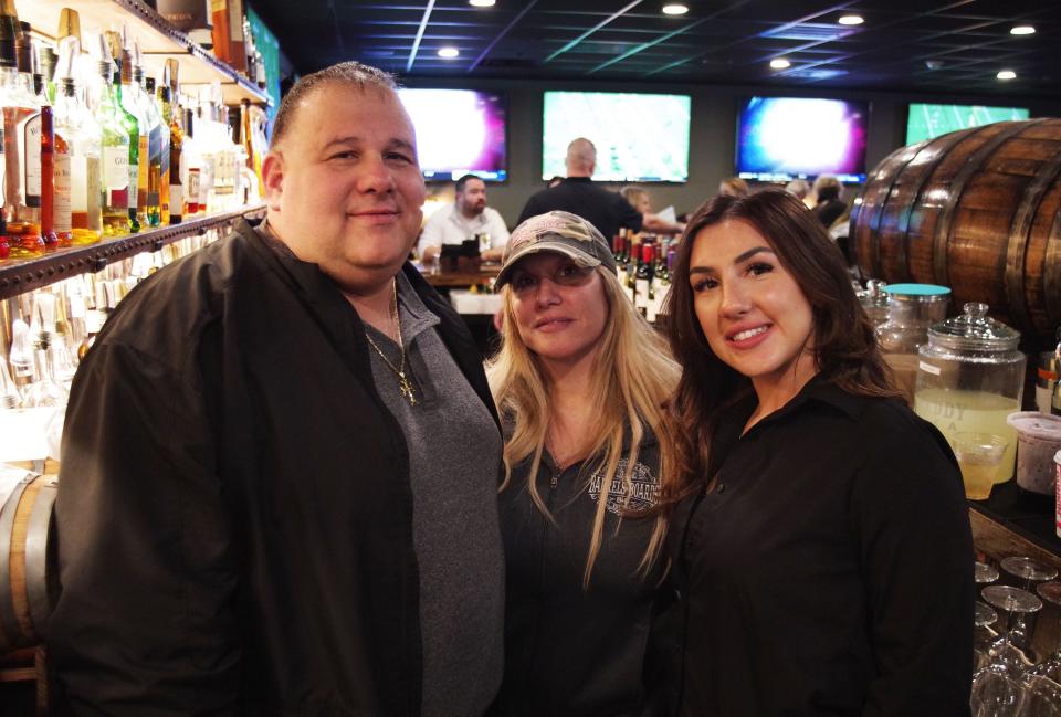 Barrels & Boards is a family owned restaurant in Raynham. Pictured here are owner Dean Saxonis, his wife Irene and daughter Andreanna, on Thursday, Dec. 28, 2023.