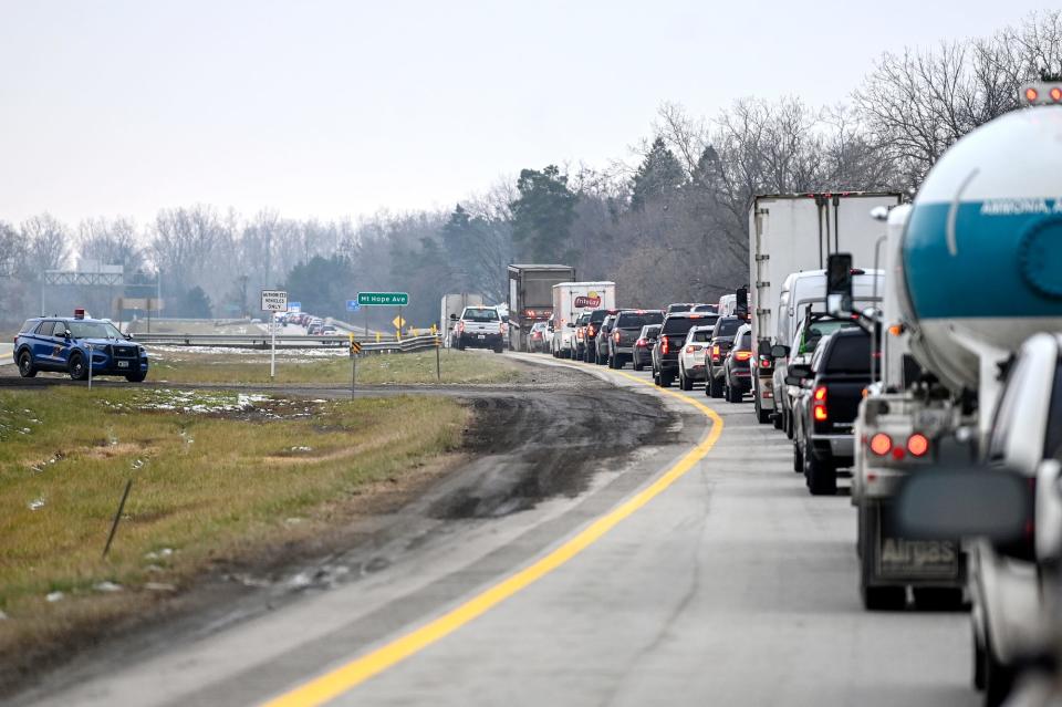 Traffic on southbound U.S. 127 is backed up north of Mt. Hope Road while first responders work the scene of an accident in the median of the highway near the Dunckel Road exit on Tuesday, Dec. 21, 2021, in Lansing.