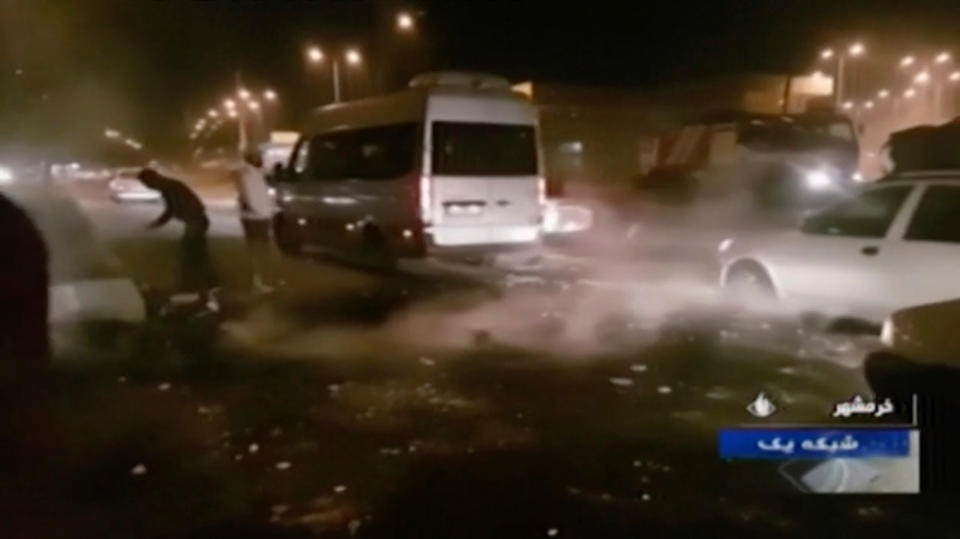 In this Saturday, Nov. 16, 2019 image from video aired by Iran's Islamic Republic of Iran Broadcasting state television channel, protesters are seen on a street in Khorramshahr, Iran. Protesters angered by Iran raising government-set gasoline prices by 50% blocked traffic in major cities and occasionally clashed with police Saturday after a night of demonstrations punctuated by gunfire, violence that reportedly killed at least one person. (IRIB via AP)