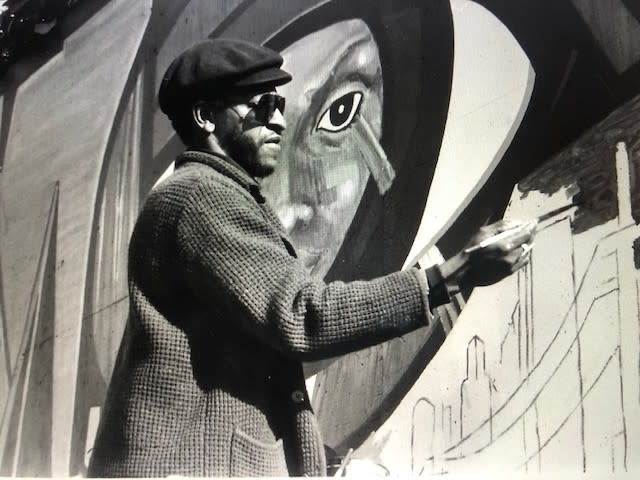 Roderick Sykes at work on one of his murals in an undated photo. Sykes, the co-founder of St. Elmo Village, died at 75.