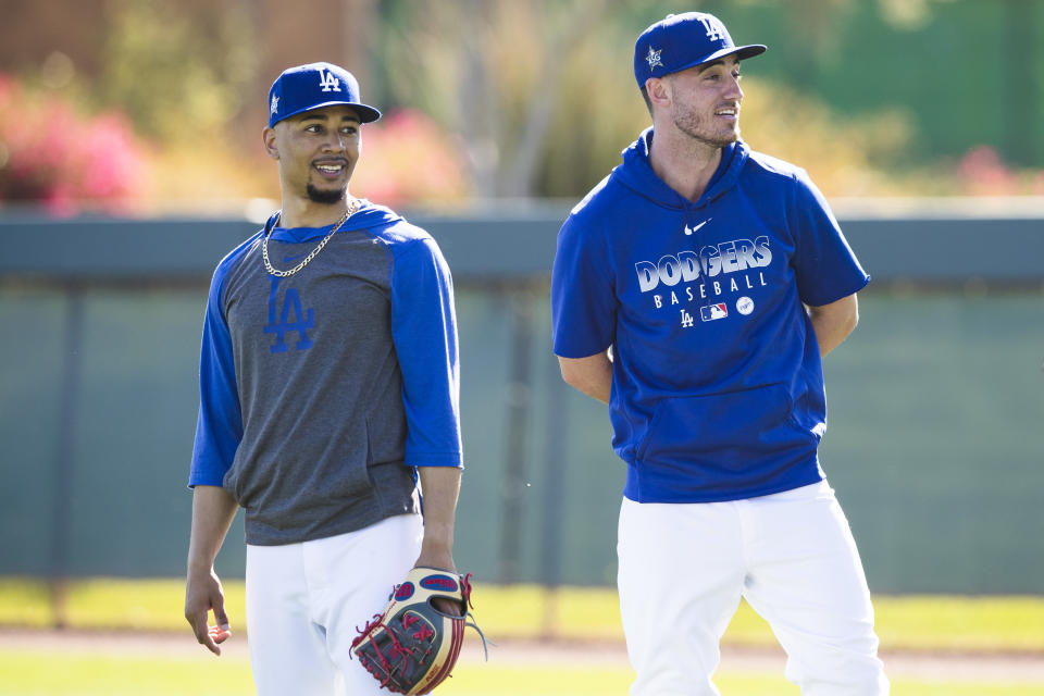 GLENDALE, AZ - FEBRUARY 20:  Mookie Betts #50 and Cody Bellinger #35 of the Los Angeles Dodgers look on during a workout after Photo Day on Thursday, February 20, 2020 at Camelback Ranch in Glendale, Arizona.  (Photo by Adam Glanzman/MLB Photos via Getty Images)