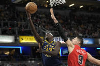 Indiana Pacers forward Pascal Siakam (43) shoots around Chicago Bulls center Nikola Vucevic (9) during the first half of an NBA basketball game in Indianapolis, Wednesday, March 13, 2024. (AP Photo/AJ Mast)