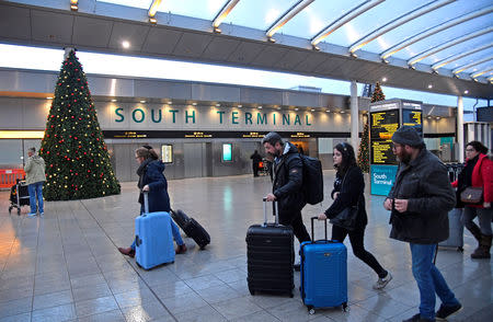 Passengers walk through the South Terminal building at Gatwick Airport, after the airport reopened to flights following its forced closure because of drone activity, in Gatwick, Britain, December 21, 2018. REUTERS/Toby Melville