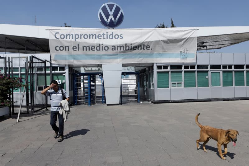 FILE PHOTO: An employee leaves the Volkswagen (VW) plant as the company will temporarily close its factories in Mexico amid growing worries over the spread of the coronavirus disease (COVID-19), in Puebla