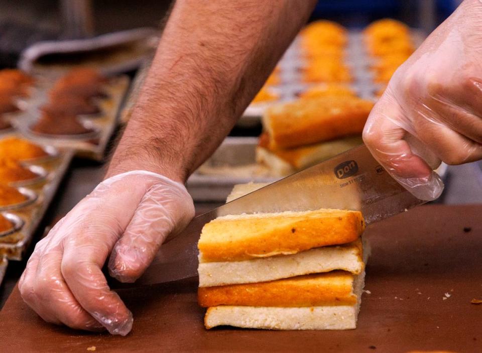 Adam Bauer, kitchen manager at Sam Jones BBQ, slices cornbread at the restaurant on Wednesday, June 5, 2024, in Raleigh, N.C.