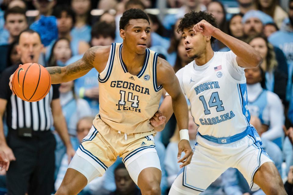 North Carolina forward Puff Johnson (14) guards Georgia Tech forward Jalon Moore (14) during an NCAA college basketball game on Saturday, Dec. 10, 2022, in Chapel Hill, N.C. (AP Photo/Jacob Kupferman)