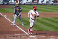 St. Louis Cardinals' Tyler O'Neill, right, scores as Milwaukee Brewers relief pitcher Freddy Peralta (51) watches during the third inning of a baseball game Sunday, Sept. 27, 2020, in St. Louis. (AP Photo/Jeff Roberson)