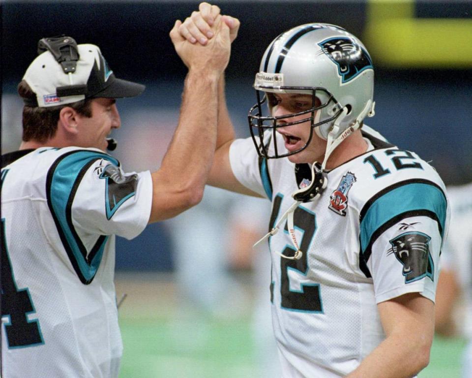 Kerry Collins (12) celebrates with backup quarterback Frank Reich after a touchdown against New Orleans on Sunday in December 1995.