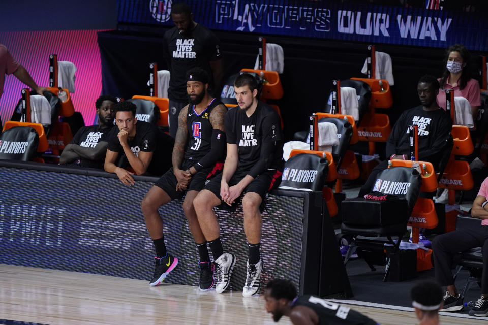 The Los Angeles Clippers players sit on the bench during the second half as they fall to the Denver Nuggets in an NBA conference semifinal playoff basketball game Tuesday, Sept. 15, 2020, in Lake Buena Vista, Fla. (AP Photo/Mark J. Terrill)