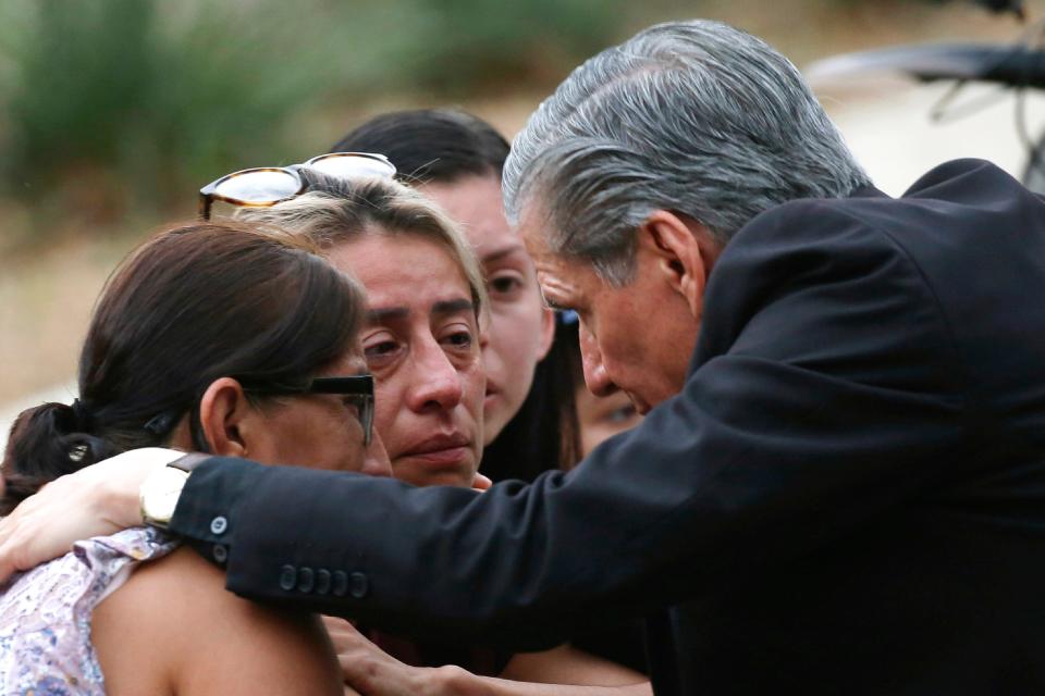 The Archbishop of San Antonio, Gustavo Garcia Seller, comforts families outside of the Civic Center following a deadly school shooting at Robb Elementary School in Uvalde, Texas Tuesday, May 24, 2022. 