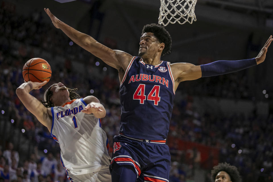 Auburn center Dylan Cardwell (44) blocks Florida guard Walter Clayton Jr. (1) during the first half of an NCAA college basketball game, Saturday, Feb. 10, 2024, in Gainesville, Fla. (AP Photo/Alan Youngblood)