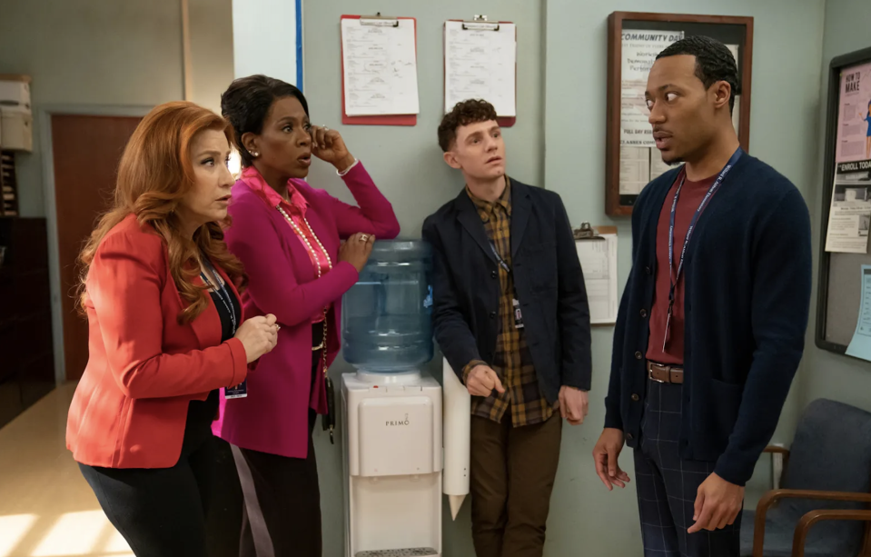 teachers huddling around a water cooler