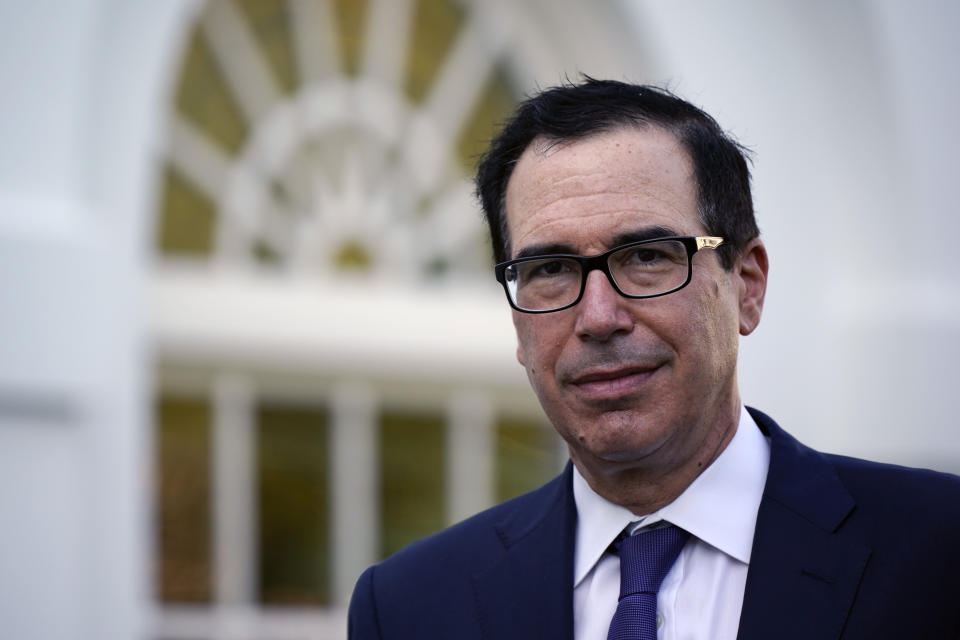 FILE - This Aug. 24, 2020 file photo shows Treasury Secretary Stephen Mnuchin at the White House in Washington. The U.S. is starting the 2021 budget year the way the old year ended, with soaring deficits. The Treasury Department reported Thursday, Nov. 12 that the federal government ran up a record October deficit of $284.1 billion, nearly double the red ink of a year ago. (AP Photo/J. Scott Applewhite, File)