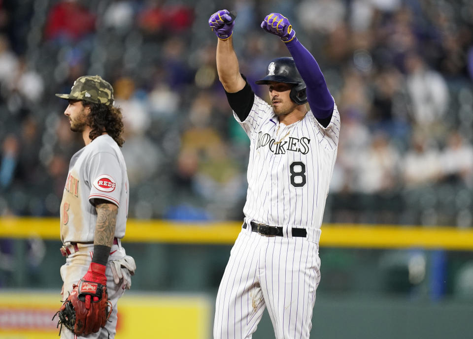 Colorado Rockies' Josh Fuentes (8) gestures toward the dugout after hitting an RBI-double off Cincinnati Reds starting pitcher Wade Miley in the fourth inning of a baseball game Friday, May 14, 2021, in Denver. (AP Photo/David Zalubowski)