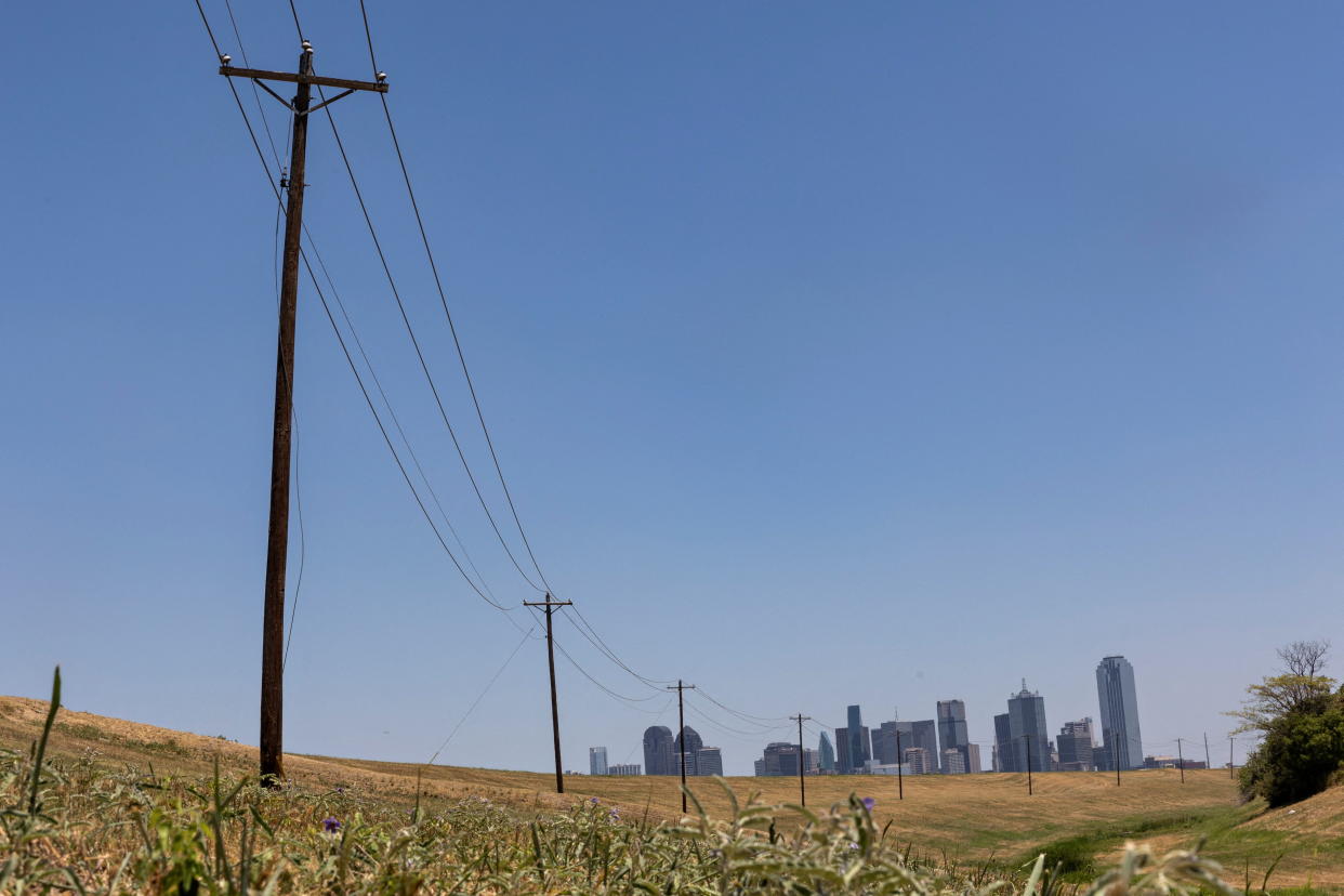 Utility poles lead to downtown Dallas.