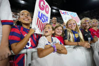 Young fans look on as they wait for members of the U.S. Soccer Federation, the U.S. Women's National Team Players Association and the U.S. National Soccer Team Players Association to sign a new collective bargaining agreements following the women's match against Nigeria at Audi Field, Tuesday, Sept. 6, 2022, in Washington. (AP Photo/Julio Cortez)