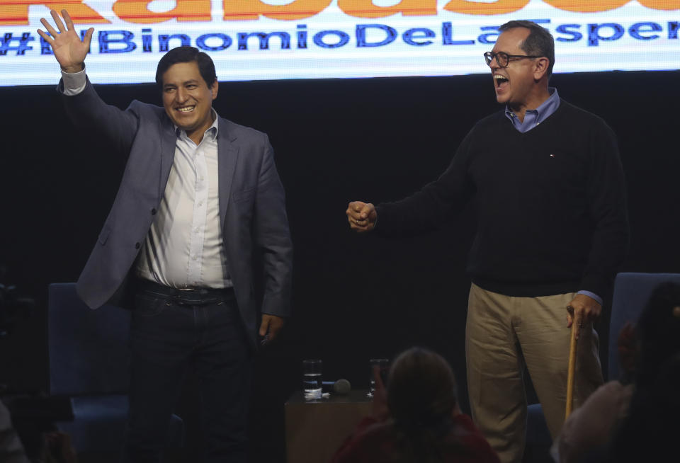 Esperanza-UNES- alliance party presidential candidate Andres Arauz, left, and his running mate Carlos Rabascall celebrate as they wait for the official results to know if they have reached the necessary percentage to win in the first electoral round, in Quito, Ecuador, Sunday, Feb. 7, 2021. (AP Photo/Dolores Ochoa)