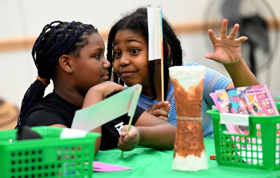 Youmarlie Joseph, 8, and Christ Michel, 10, enjoy making Juneteenth flags Friday at the Manatee County Central Library during the 7th annual Juneteenth Reading Conference.