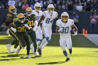 Los Angeles Chargers running back Austin Ekeler (30) runs with the ball against the Green Bay Packers during the first half of an NFL football game, Sunday, Nov. 19, 2023, in Green Bay, Wis. (AP Photo/Mike Roemer)