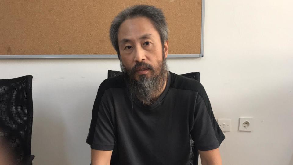 In this image released by the Hatay governorate in Turkey, Jumpei Yasuda of Japan, talks in Antakya, Turkey, Wednesday, Oct. 24, 2018. Japan confirmed Wednesday that a man freed from Syria is the Japanese freelance journalist Yusuda, who was kidnapped three years ago by al-Qaida's branch in Syria, known at the time as the Nusra Front, and said he appears to be in good health. (Antakya Governorate via AP)