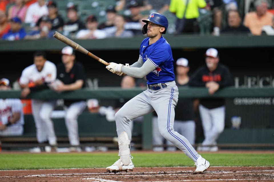 Toronto Blue Jays' Cavan Biggio follows through on a swing against the Baltimore Orioles during the third inning of a baseball game, Wednesday, June 14, 2023, in Baltimore. (AP Photo/Julio Cortez)