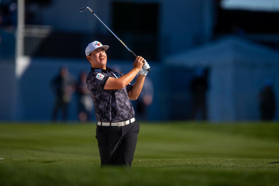 Sungjae Im watches the ball after he plays his second shot at the 10th hole during round two of the WM Phoenix Open at TPC Scottsdale on Feb. 10, 2023.