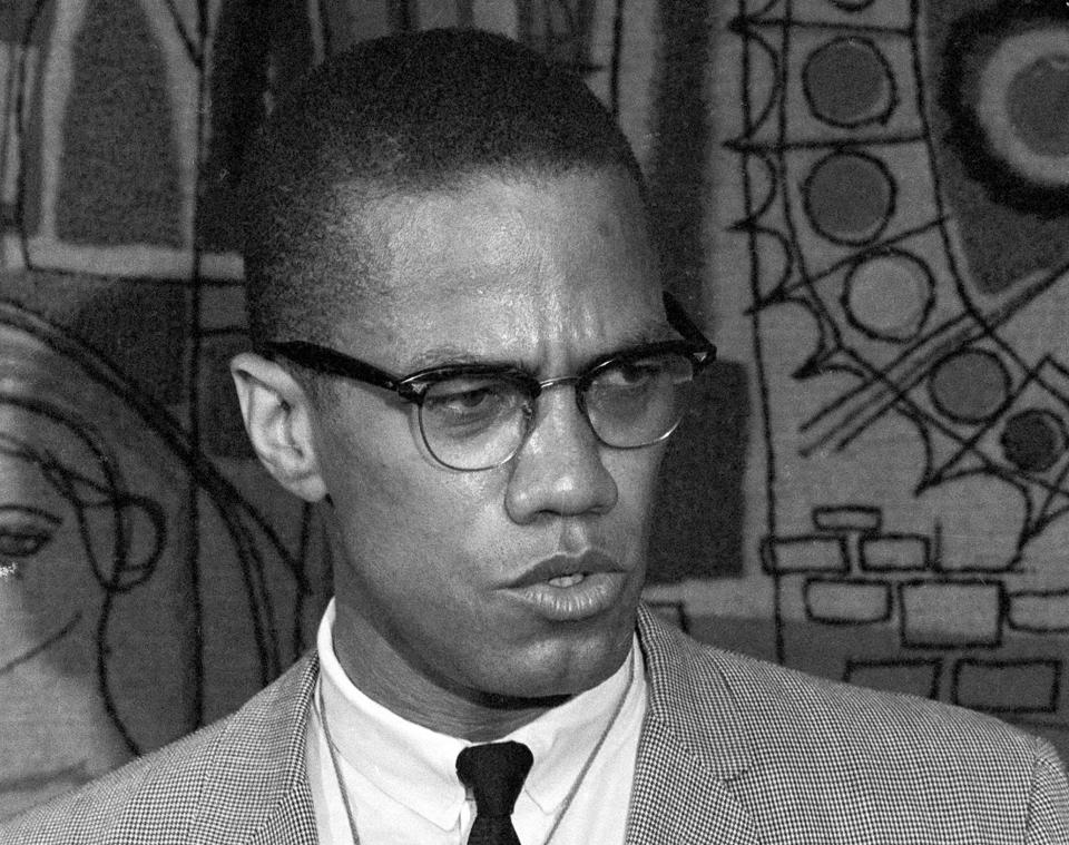 FILE - Malcolm X addresses reporters at the Hotel Park-Sheraton in New York City on March 12, 1964. Two men convicted in the assassination of Malcolm X are set to be cleared after more than half a century, with prosecutors now saying authorities withheld evidence in the civil rights leader's killing, according to a news report Wednesday, Nov. 17, 2021. (AP Photo, File)