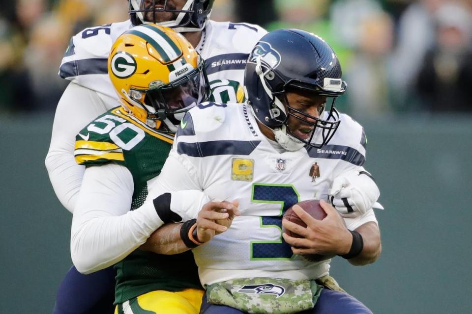 Green Bay Packers’ Whitney Mercilus sacks Seattle Seahawks’ Russell Wilson during the first half of an NFL football game Sunday, Nov. 14, 2021, in Green Bay, Wis. (AP Photo/Aaron Gash)