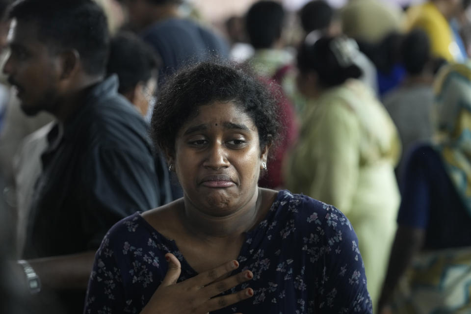 An asthma patient reacts after swallowing a live fish stuffed with a herbal paste in Hyderabad, India, Saturday, June 8, 2024. Every year thousands of asthma patients arrive here to receive this fish therapy from the Bathini Goud family, which keeps a secret formula of herbs, handed down by generations only to family members. The herbs are inserted in the mouth of a live sardine, or murrel fish, and slipped into the patient's throat. (AP Photo/Mahesh Kumar A.)