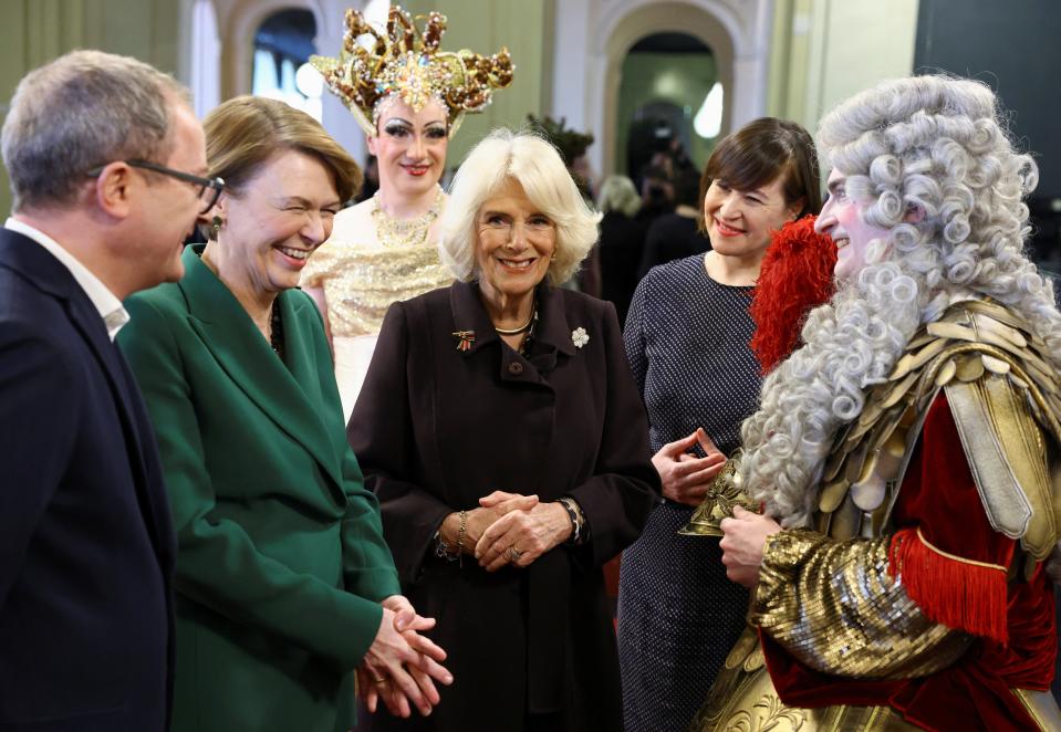 Britain’s Camilla, the Queen Consort, and Germany’s first lady Elke Buedenbender react as they talk with a Komische Oper Berlin performer, next to Managing Director Susanne Moser, during a tour of the opera house in Berlin (REUTERS)