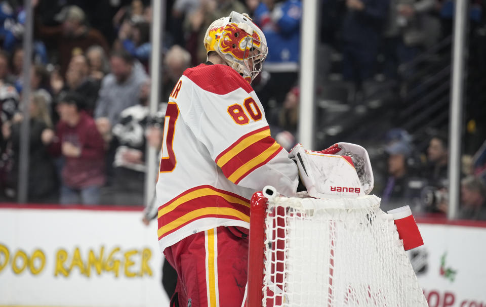 Calgary Flames goaltender Dan Vladar reacts after giving up the go-ahead goal to Colorado Avalanche center Nathan MacKinnon in the third period of an NHL hockey game Monday, Dec. 11, 2023, in Denver. (AP Photo/David Zalubowski)