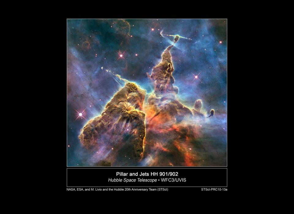 Hubble's 20th anniversary image shows a mountain of dust and gas rising in the Carina Nebula. The top of a three-light-year tall pillar of cool hydrogen is being worn away by the radiation of nearby stars, while stars within the pillar unleash jets of gas that stream from the peaks.  Credit: NASA, ESA, and M. Livio and the Hubble 20th Anniversary Team (STScI)