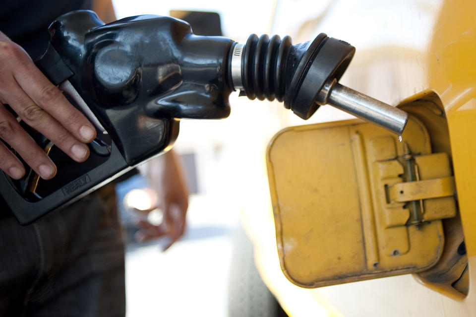 FILE - In this Aug. 10, 2012 file photo a customer pumps gas into his dual-tank pickup truck at a 76 gas station in Los Angeles. California regulators will hold a public hearing on Thursday, Dec. 12, 2019 about whether to require a certain percentage of truck sales to be zero emission vehicles. California has some of the worst air quality in the nation, largely driven by pollution from cars and trucks. (AP Photo/Grant Hindsley, File)