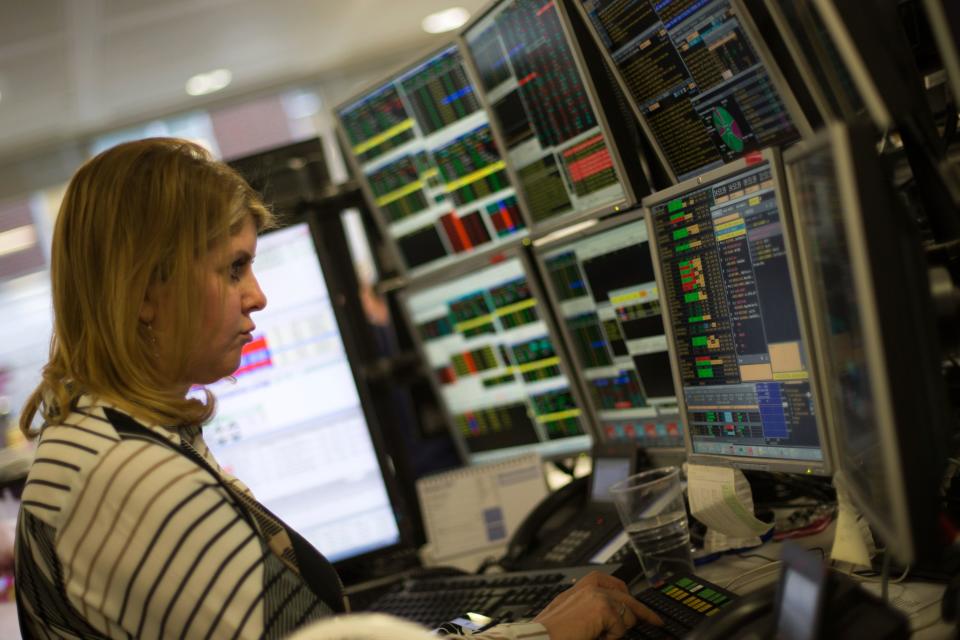 A trader studies information on trading screens at ETX Capital in central London on January 3, 2017. London's FTSE 100 reached a historic peak at 7,205.21 points in morning trade, extending a record run seen in the final week of 2016, before easing back from its highs. Since Britain's vote in favour of Brexit, London's FTSE 100 blue-chip index has soared thanks in large part to a weaker pound, even as the economy appears to have shrugged off the impact of the country's impending divorce from the European Union. / AFP PHOTO / Daniel LEAL-OLIVAS        (Photo credit should read DANIEL LEAL-OLIVAS/AFP via Getty Images)