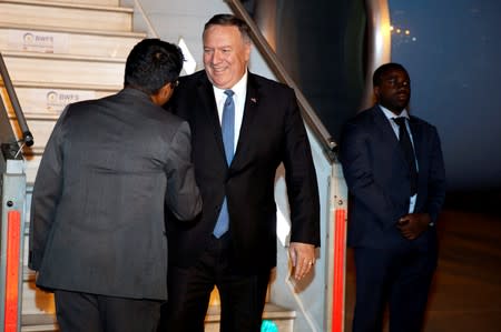 India's Deputy Chief of Protocol Shri Mayank Singh, left, greets U.S Secretary of State Mike Pompeo on arrival in New Delhi