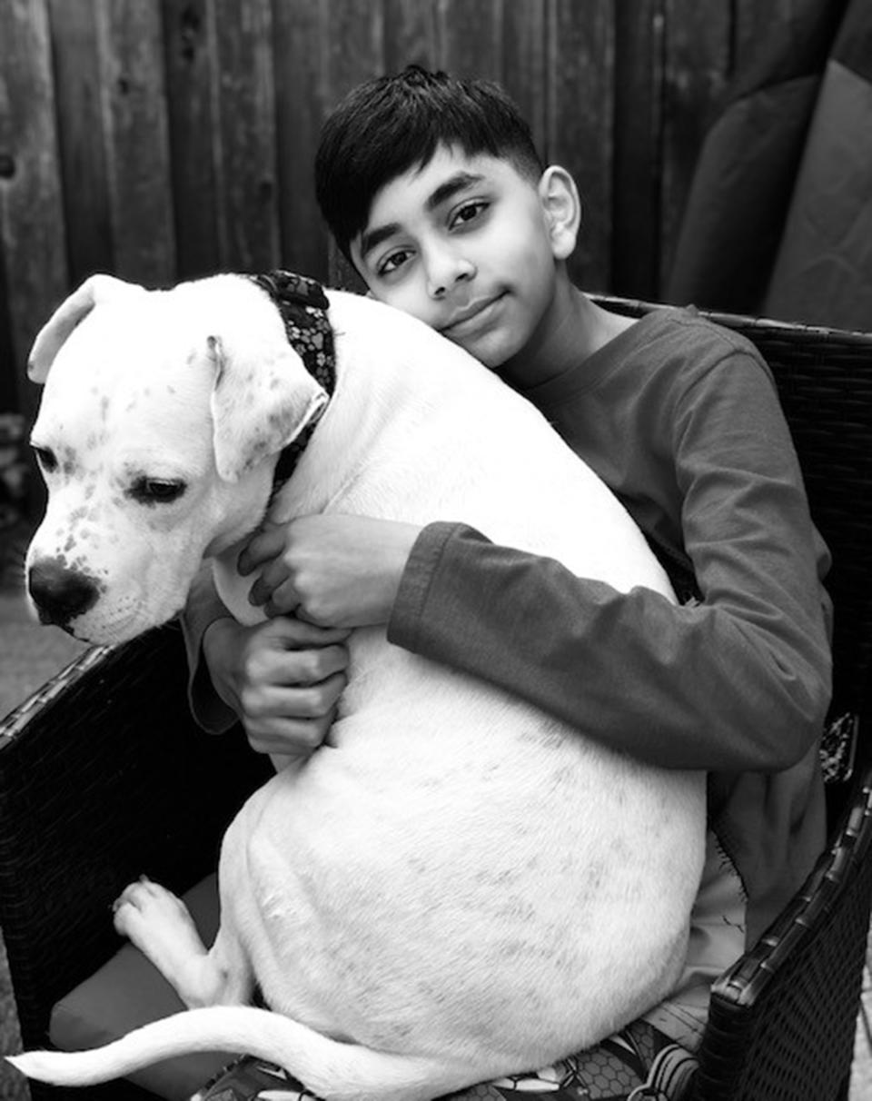 ASPCA Kid of the Year Evan Bisnauth snuggles a dog. (ASPCA)